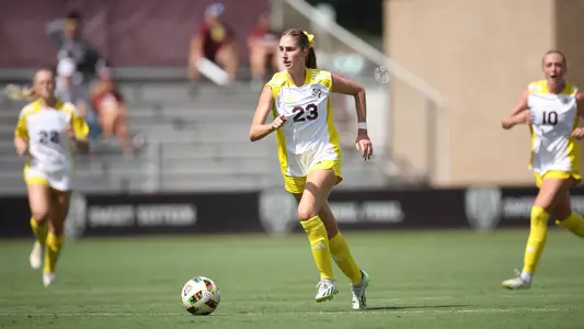 Georgia Leb patrols the midfield sporting the Aggies' Turn It Gold Jerseys