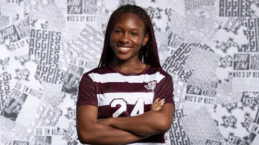 Taylor Jernigan in the preseason photo shoot with her arms crossed and a smile as she's ready to take out the competition.