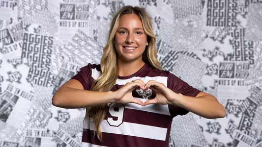 Taylor Pounds cleverly uses her hands to make the shape of a heart, as young ladies are known to do on the social media, over the Texas A&M logo on her maroon jersey at media day portrait shoot.