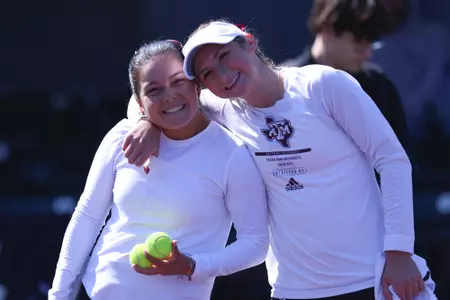 COLLEGE STATION, TX - February 16, 2025 - Luciana Perez of the Texas A&M Aggies and Mary Stoiana of the Texas A&M Aggies during the game between the Pepperdine Waves and the Texas A&M Aggies at Mitchell Tennis Center in College Station, TX. Photo By Bailee Wagner/Texas A&M Athletics
