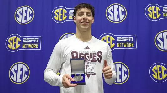 Baylor Nelson with his silver medal from the 400 IM at SEC Championships