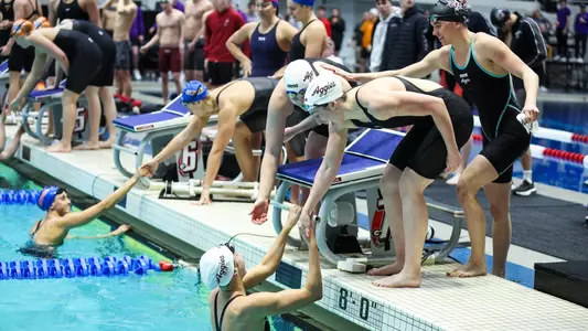 The 200 medley relay team celebrating