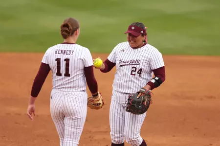 COLLEGE STATION, TX - March 23, 2025 - Emiley Kennedy #11 of the Texas A&M Aggies and Mya Perez #24 of the Texas A&M Aggies during the game between the Alabama Crimson Tide and the Texas A&M Aggies at Davis Diamond in College Station, TX. Photo By Evan Pilat/Texas A&M Athletics