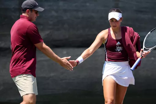 COLLEGE STATION, TX - April 13, 2025 - Associate Head Coach James Wilson of the Texas A&M Aggies and Mia Kupres of the Texas A&M Aggies during the game between the Georgia Bulldogs and the Texas A&M Aggies at Mitchell Tennis Center in College Station, TX. Photo By Julianne Shivers/Texas A&M Athletics