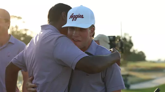 Vishnu and Wheaton celebrate the SEC semifinal win with a greenside embrace.