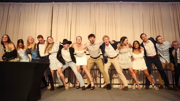Seniors sawing on stage at the end of the swimming & diving team banquet
