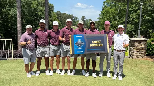 The Texas A&M men's golf team poses with the NCAA "Ticket Punched" sign after finishing runner-up at the Auburn Regional