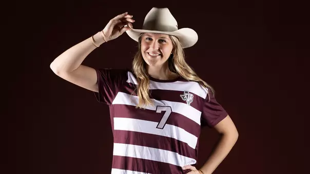 Kaylee Noble gives a tip of her cowboy hat at the portrait shoot during her recruiting trip.