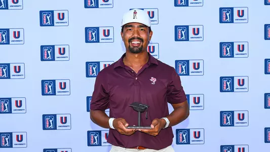 Phichaksn Maichon accepts a trophy for his sixth-place finish in the PGA Tour University rankings