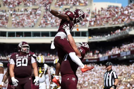 COLLEGE STATION, TX - October 05, 2024 - Running back Le'Veon Moss #8 of the Texas A&M Aggies and Offensive lineman Chase Bisontis #71 of the Texas A&M Aggies during the game between the Missouri Tigers and the Texas A&M Aggies at Kyle Field in College Station, TX. Photo By Zoie Joslin/Texas A&M Athletics