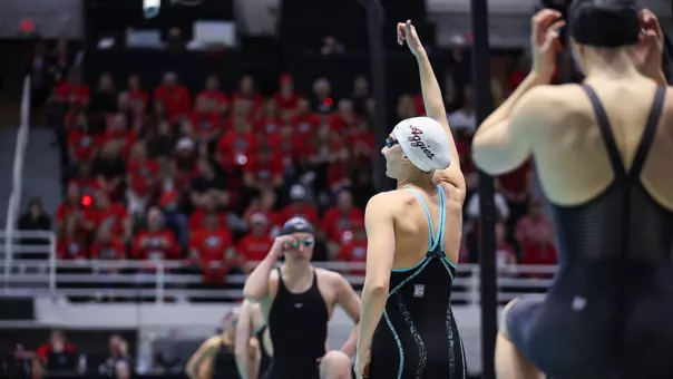 Chloe Stepanek giving a Gig 'Em on the blocks at SEC Championships