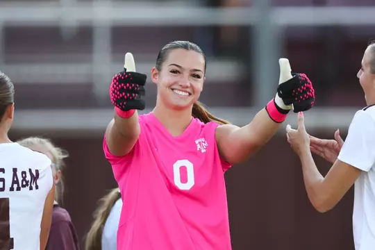 Sydney Fuller gives a double Gig 'em in her goalkeeper gloves during pregame introductions