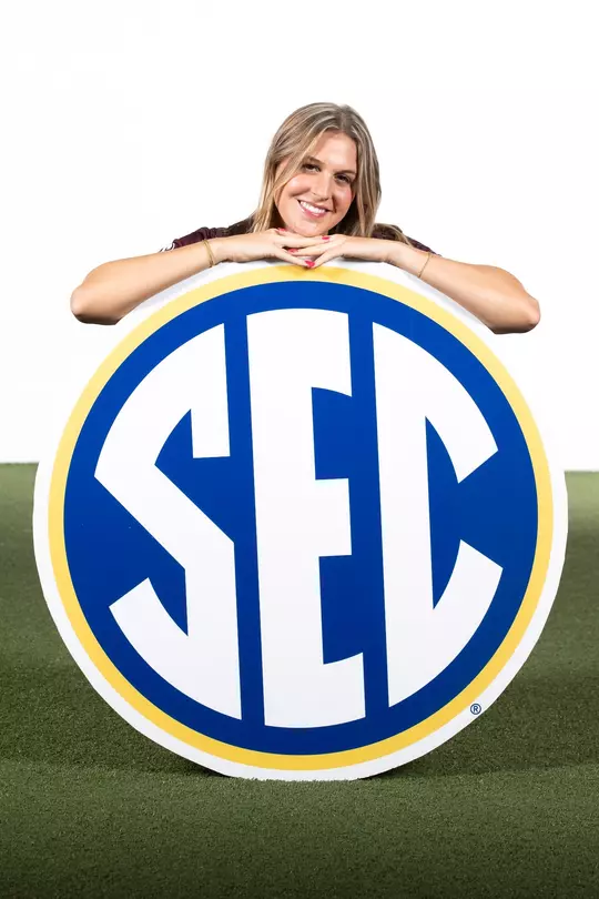 Kaylee Noble poses with a really really really big SEC logo