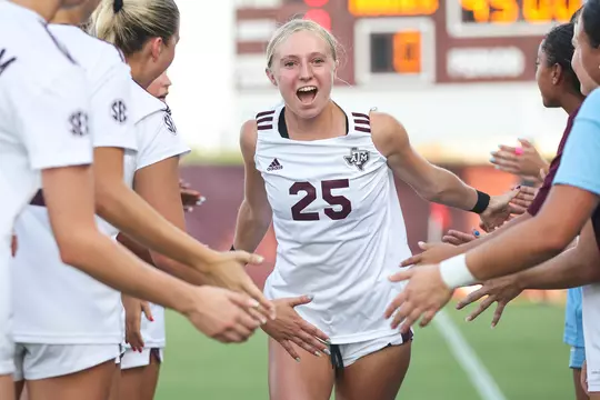 Savannah Hutchins slaps skin during starting intros