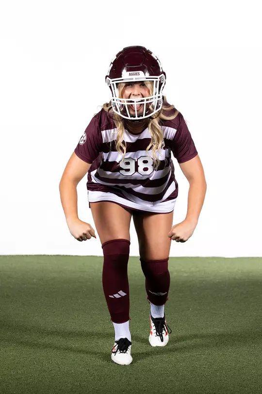 Shea Ryan dons an Aggie football helmet and goes hulk style at her media day portrait shoot.
