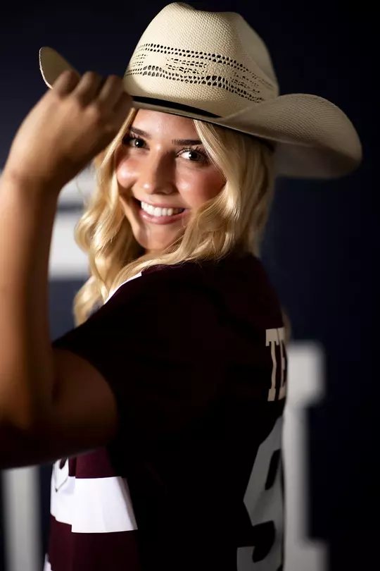 Shea Ryan tips her cowboy hat in her media day portrait shoot