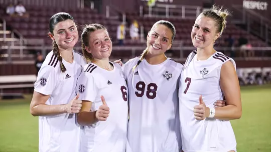 Lucy Landherr, Bailey Cate, Shea Ryan and Kaylee Noble shot Gig 'em thumbs after match