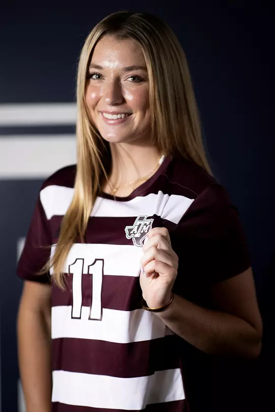Riley Crooks pops the A&M logo during her 2025 media day portrait shoot
