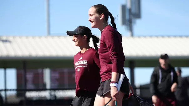 Violeta Martinez and Anna Perelman enjoy a precious moment during doubles action vs. Tulane