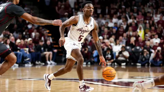 Jacari Lane dribbling the ball up the court against Oklahoma