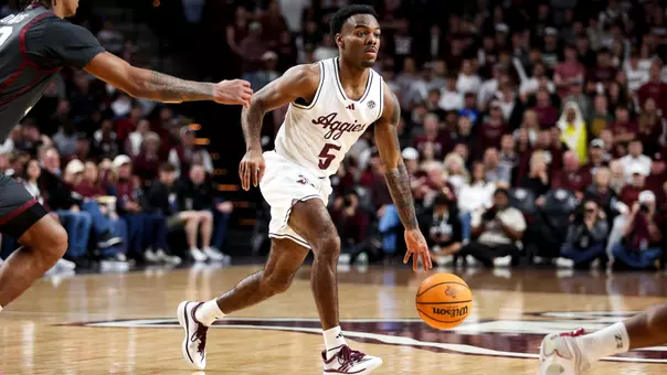 Jacari Lane dribbling the ball up the court against Oklahoma