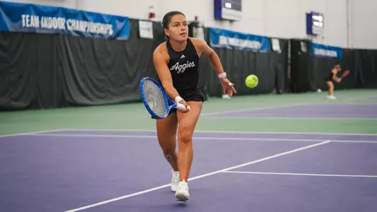 Lucciana Perez volleys against Ohio State at the ITA National Team Indoor Championship in Evanston, Illinois