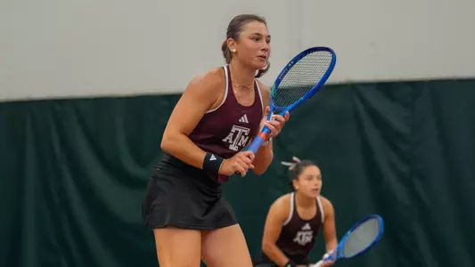 Mia Kupres awaits a service from Vanderbilt with Lucciana Perez looking on in SEC Championship quarterfinal action at Oklahoma's Headington Family Tennis Center indoor courts