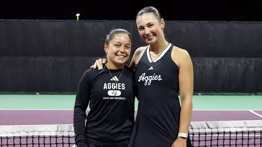 Lucciana Perez and Mia Kupres share a precious moment following the 2026 Senior Night festivities at Mitchell Tennis Center