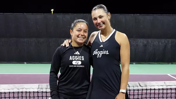 Lucciana Perez and Mia Kupres share a precious moment following the 2026 Senior Night festivities at Mitchell Tennis Center