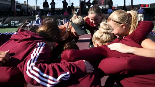 The women's team circles up for a raucous hype-up huddle up before a match against Sam Houston