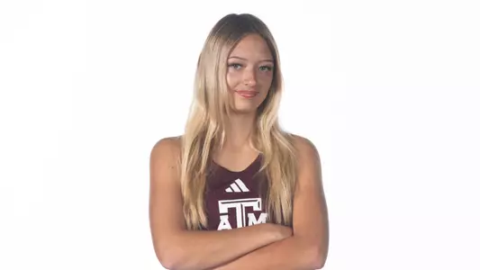 Sydney Jara poses with arms folded for her recruiting visit portrait shoot.