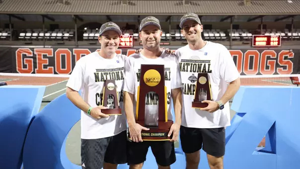 Coaches with the National Championship trophies. James Wilson, Mark Weaver and Tommy Mylnikov pose with their hardware.