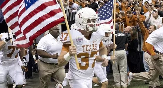 121229 Nate Boyer at Alamo Bowl, carrying flag