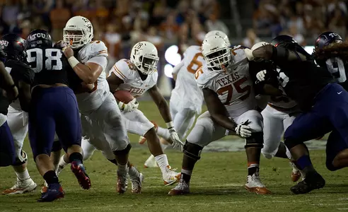 D. Espinosa and T. Hopkins open a hole for Malcolm Brown.