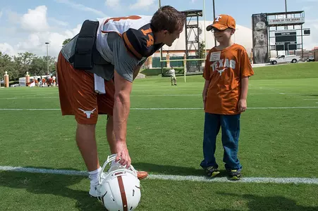 QB David Ash (14) with practice guest Mason Burkett