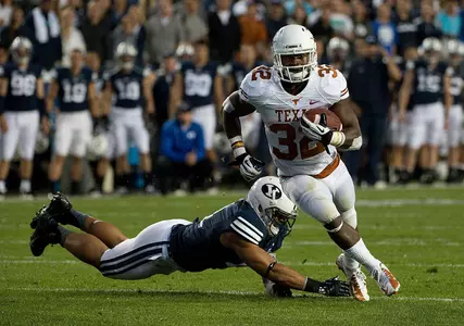 Johnathan Gray runs past a BYU player