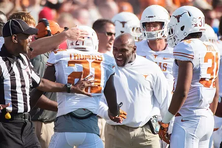 Charlie Strong congratulates (21) CB Duke Thomas.