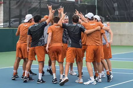 men's tennis team huddle