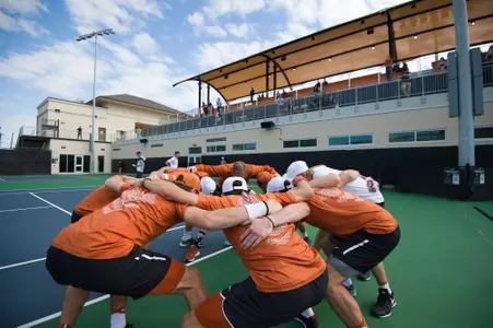 men's tennis team huddle