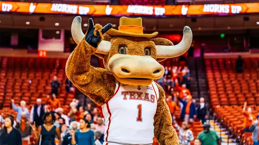 Texas' official costumed mascot, Hook 'Em, holds his horns up at a Texas Women's Basketball game