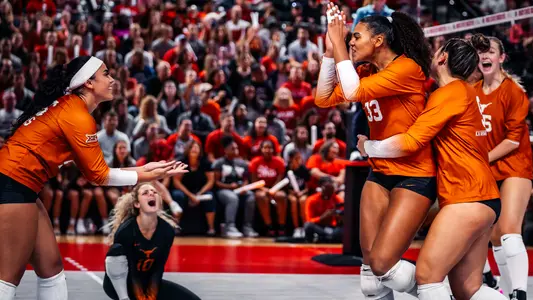 Texas celebrates a kill in Saturday's 3-1 win in Columbus