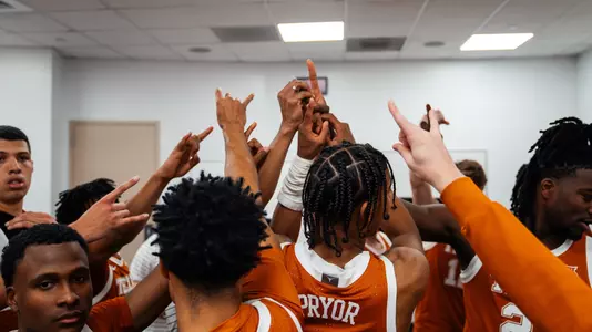 locker room team huddle after Louisville win