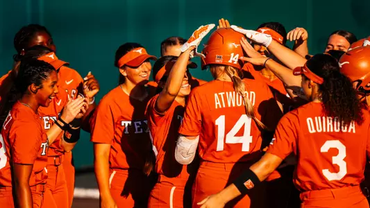 Reese Atwood is met by her teammates following a homer in Wednesday's game at Texas State