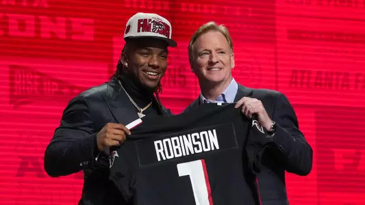 Apr 27, 2023; Kansas City, MO, USA; Texas running back Bijan Robinson with NFL commissioner Roger Goodell after being selected by the Atlanta Falcons eighth overall in the first round of the 2023 NFL Draft at Union Station. Mandatory Credit: Kirby Lee-USA TODAY Sports
