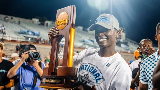 Julien Alfred poses with the National Championship trophy