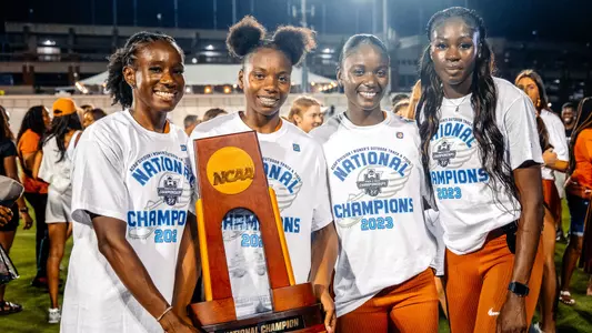 The Texas 4x100 relay team with the National Championship trophy