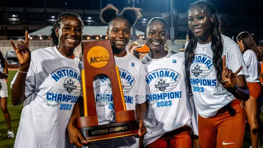 The Texas 4x100 relay team with the National Championship trophy