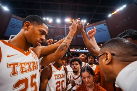 Texas mbb pre-game team huddle with Coach Rodney Terry