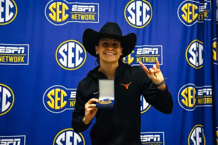 Emma Sticklen holding her first-place medal after winning the 200 IM at the 2025 SEC Championships