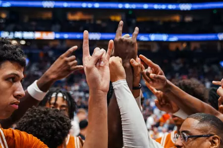 mbb pre-game huddle Hook 'em